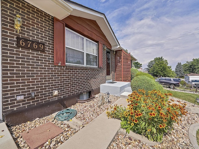 6769 W 70th Ave, Arvada, CO 80003 - view of side of property featuring brick siding