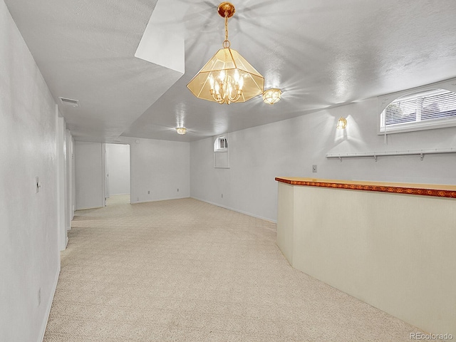 6769 W 70th Ave, Arvada, CO 80003 - below grade area with light colored carpet and a chandelier