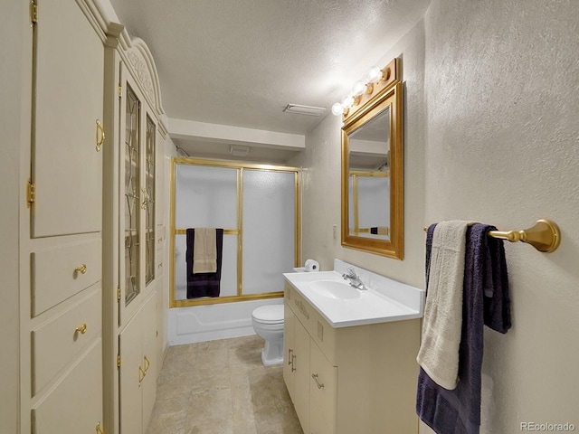 6769 W 70th Ave, Arvada, CO 80003 - bathroom with vanity, a textured wall, toilet, enclosed tub / shower combo, and a textured ceiling
