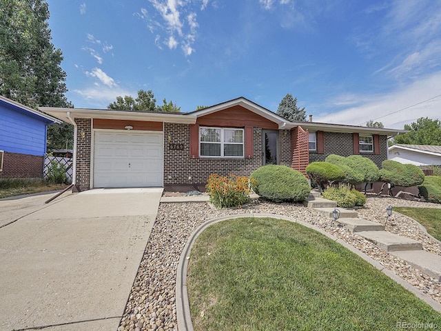 6769 W 70th Ave, Arvada, CO 80003 - ranch-style house with concrete driveway, brick siding, and a garage