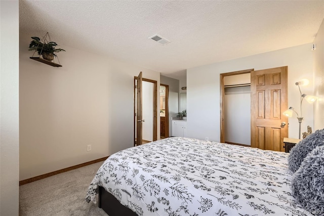 carpeted bedroom with a textured ceiling and a closet