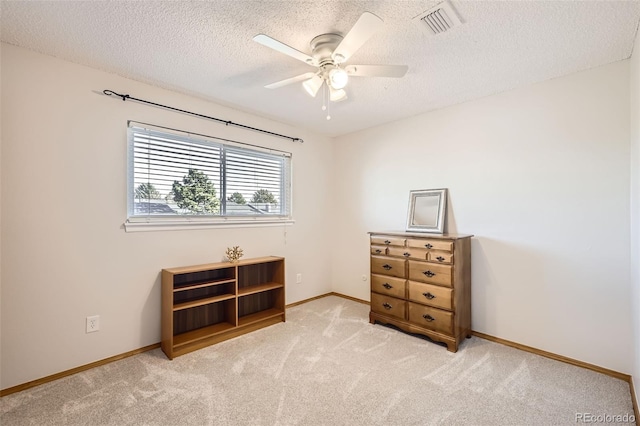 interior space featuring light carpet, a textured ceiling, and ceiling fan