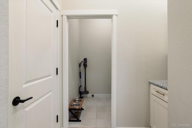 laundry area with light tile patterned floors