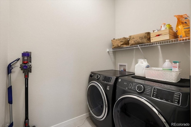 clothes washing area with tile patterned floors and independent washer and dryer