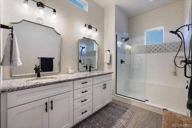 bathroom featuring vanity and a tile shower