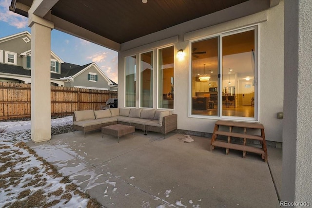 snow covered patio featuring an outdoor living space