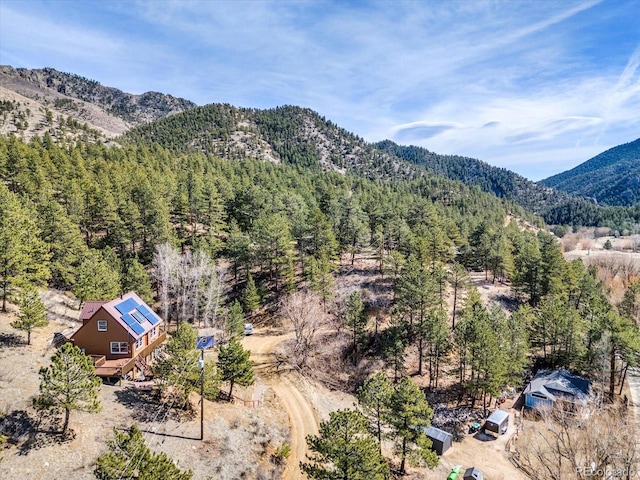 exterior space with a mountain view and a view of trees