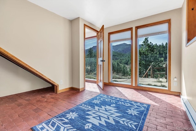 entryway featuring baseboards and brick floor