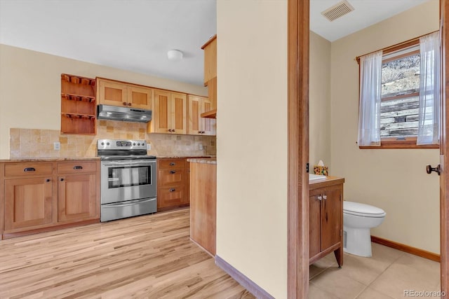 kitchen featuring electric range, visible vents, under cabinet range hood, open shelves, and backsplash