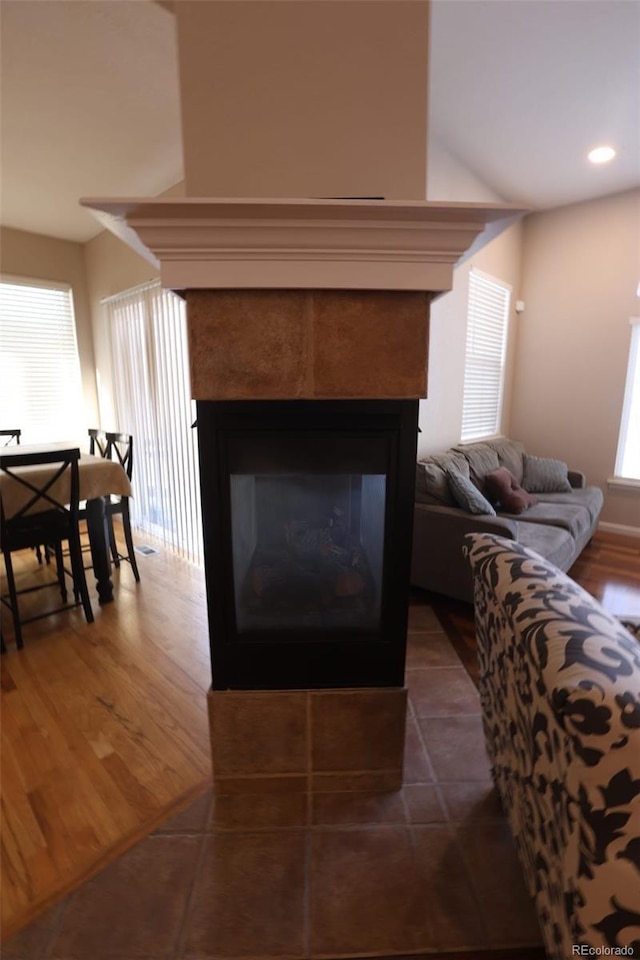 living room with dark hardwood / wood-style floors and a fireplace