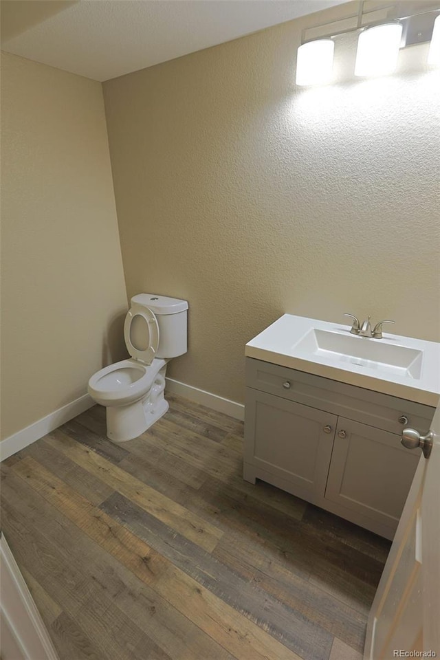 bathroom featuring hardwood / wood-style floors, toilet, and vanity