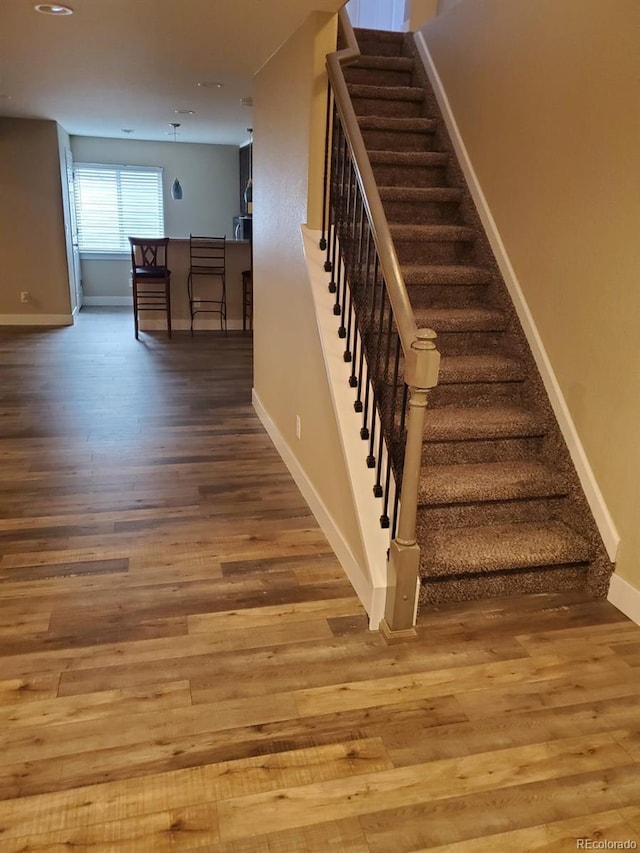 stairs with wood-type flooring