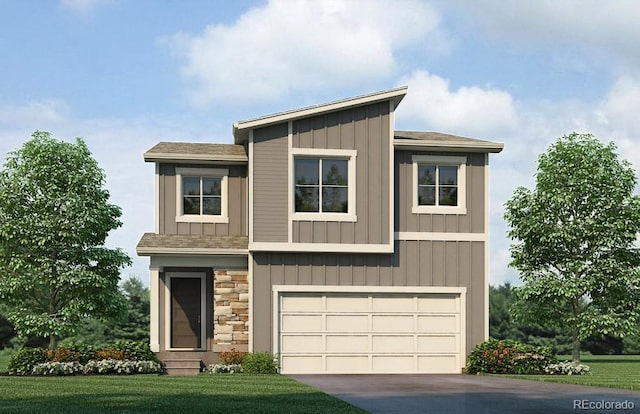 view of front of home with a front yard and a garage