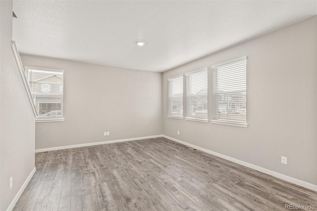 spare room with hardwood / wood-style flooring