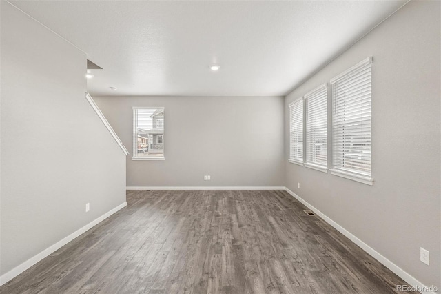 unfurnished room featuring dark hardwood / wood-style floors