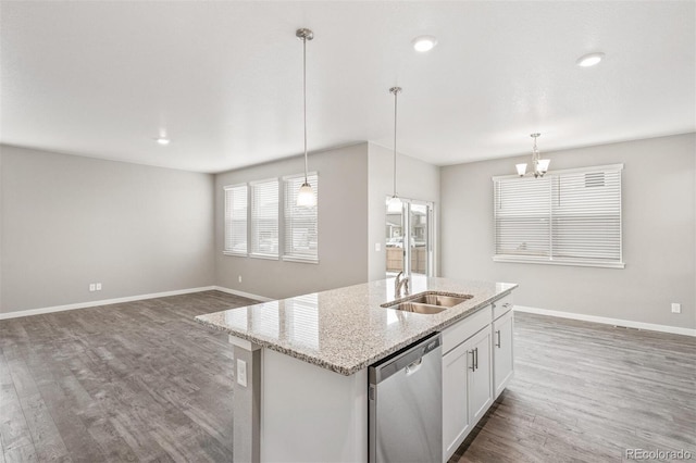 kitchen featuring dark hardwood / wood-style flooring, dishwasher, white cabinets, and decorative light fixtures