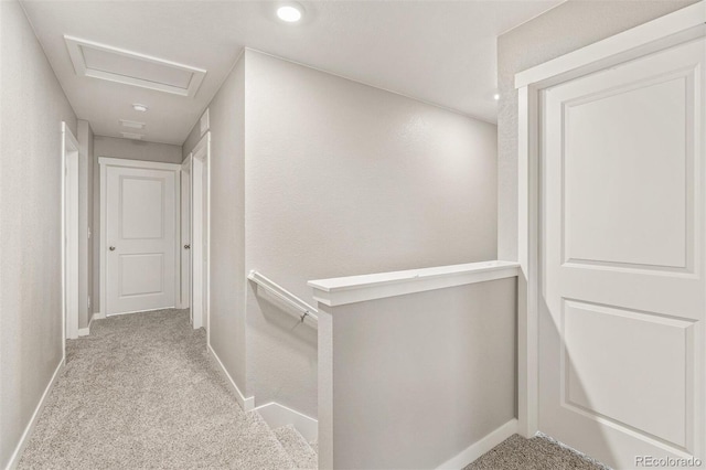 hallway featuring light colored carpet