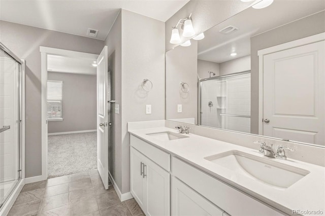 bathroom with tile patterned floors, vanity, and walk in shower