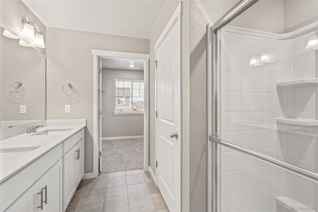 bathroom with vanity, tile patterned floors, and a shower with door