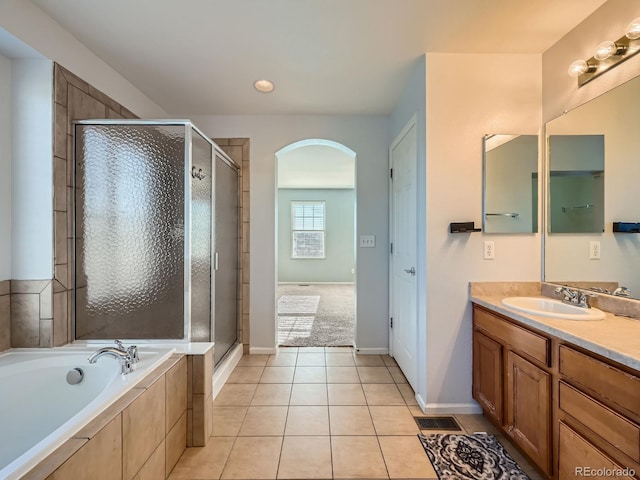 bathroom featuring tile patterned flooring, vanity, and independent shower and bath