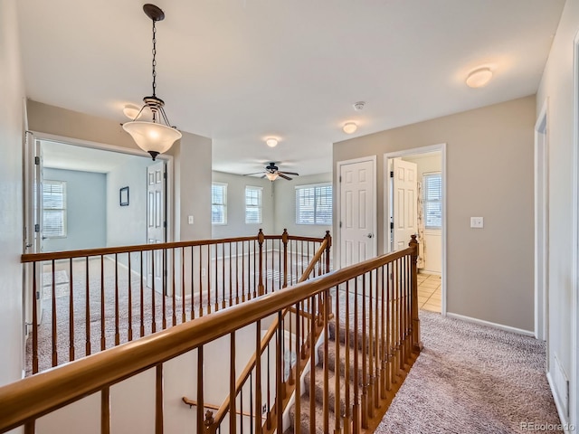 hallway featuring light carpet