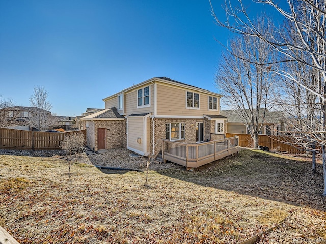 rear view of property featuring a wooden deck