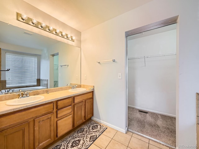 bathroom featuring tile patterned floors, vanity, and a bathtub