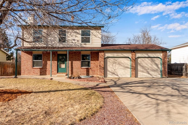 traditional-style house with concrete driveway, a garage, fence, and brick siding