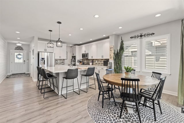 16486 W 94th Dr, Arvada, CO 80007 - dining area featuring plenty of natural light, recessed lighting, and light wood-style flooring