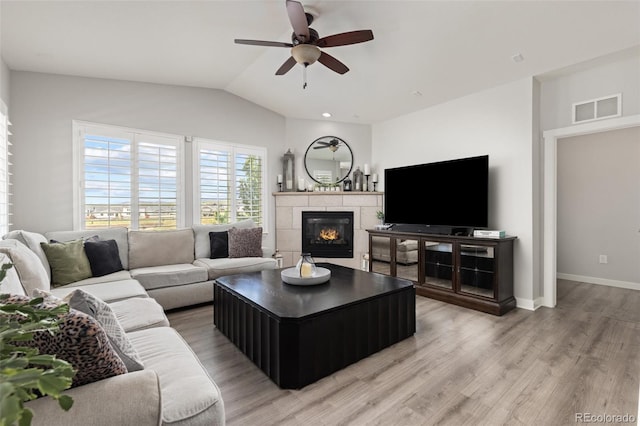 16486 W 94th Dr, Arvada, CO 80007 - living area with a ceiling fan, a fireplace, vaulted ceiling, and light wood-type flooring