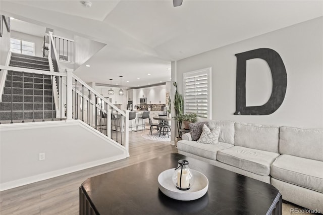 16486 W 94th Dr, Arvada, CO 80007 - living room featuring light wood-type flooring, stairway, and recessed lighting