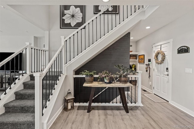 16486 W 94th Dr, Arvada, CO 80007 - staircase featuring a high ceiling, wood finished floors, and recessed lighting