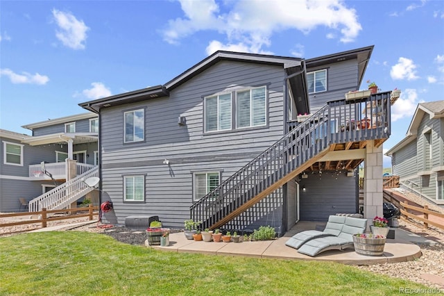 16486 W 94th Dr, Arvada, CO 80007 - rear view of house with stairs, a fenced backyard, a patio, and a deck