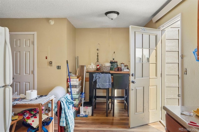2480 Allegheny Dr, Colorado Springs, CO 80919 - dining room featuring light wood-style flooring and a textured ceiling