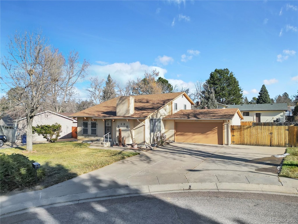 single story home featuring a garage and a front lawn