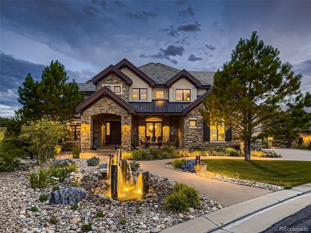 craftsman-style house featuring a porch and a lawn