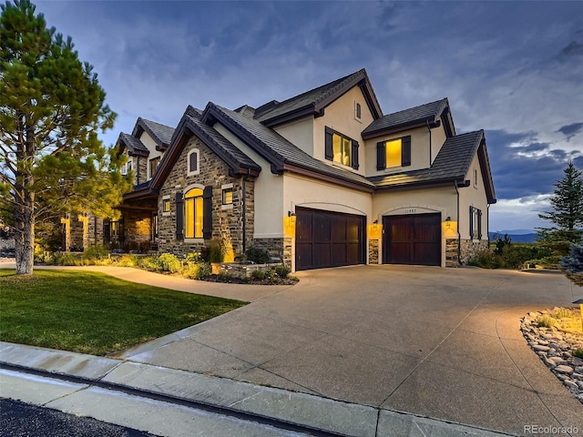 view of front of home featuring a garage and a front lawn