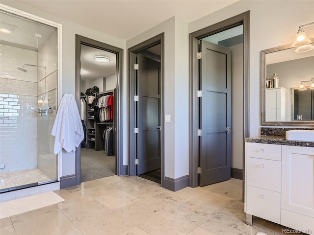 bathroom featuring vanity and tiled shower