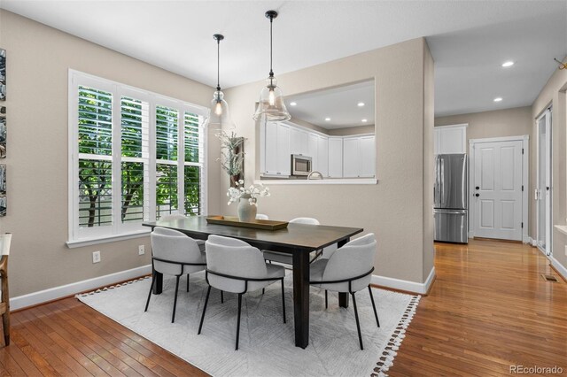 7746 E Severn Pl, Denver, CO 80230 - dining room with light wood finished floors and recessed lighting