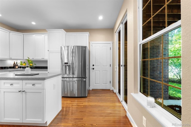 7746 E Severn Pl, Denver, CO 80230 - kitchen featuring stainless steel refrigerator with ice dispenser, light wood-style flooring, white cabinets, and recessed lighting