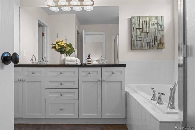 7746 E Severn Pl, Denver, CO 80230 - bathroom featuring double vanity, tile patterned flooring, a garden tub, and a shower with door