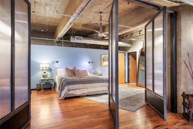 2000 Little Raven St Unit 1B, Denver, CO 80202 - bedroom with wood finished floors and rail lighting