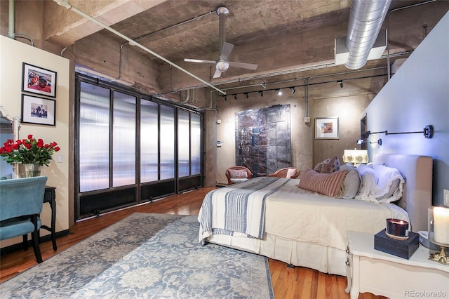 2000 Little Raven St Unit 1B, Denver, CO 80202 - bedroom featuring rail lighting and wood finished floors