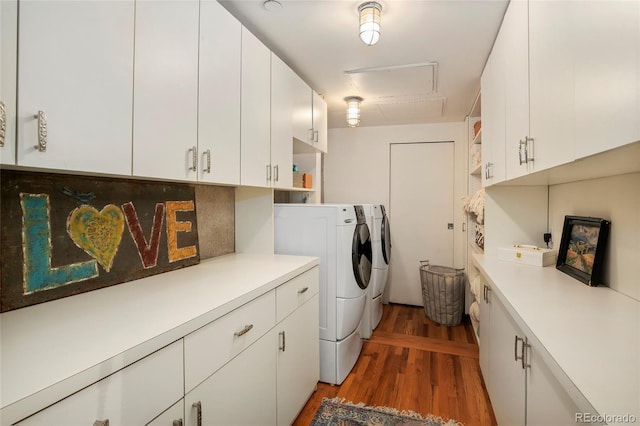 2000 Little Raven St Unit 1B, Denver, CO 80202 - clothes washing area featuring washer and dryer, cabinet space, and light wood finished floors