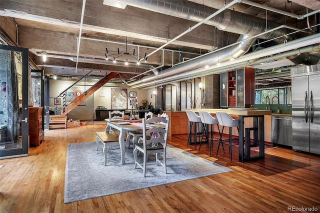 2000 Little Raven St Unit 1B, Denver, CO 80202 - dining space featuring wood finished floors and stairway