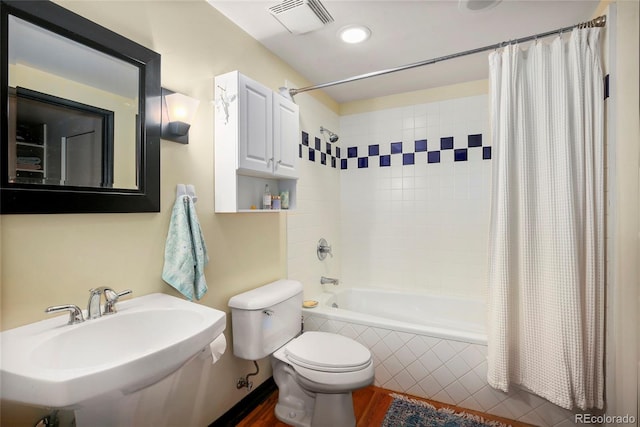 2000 Little Raven St Unit 1B, Denver, CO 80202 - bathroom featuring a sink, toilet, tiled shower / bath combo, wood finished floors, and recessed lighting