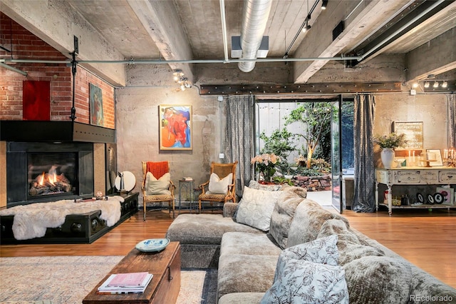 2000 Little Raven St Unit 1B, Denver, CO 80202 - living room featuring wood finished floors, track lighting, and a brick fireplace