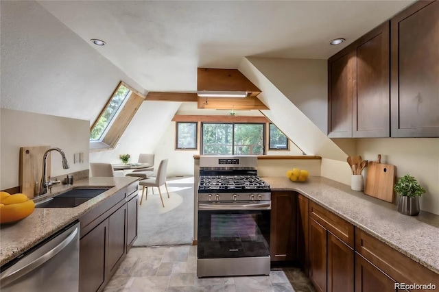 100 Aspen Ln, Evergreen, CO 80439 - kitchen with stainless steel appliances, a sink, light stone counters, a skylight, and lofted ceiling