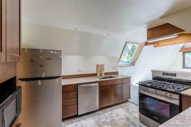 100 Aspen Ln, Evergreen, CO 80439 - kitchen featuring appliances with stainless steel finishes, a sink, a skylight, healthy amount of natural light, and a textured ceiling