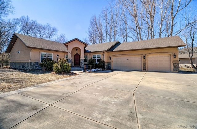 view of front of property with a garage, stone siding, concrete driveway, and stucco siding